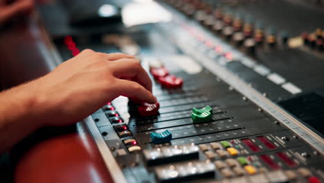 close-up of a hand adjusting sound mixer