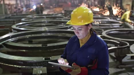 female engineer inspecting metal fabrication plant