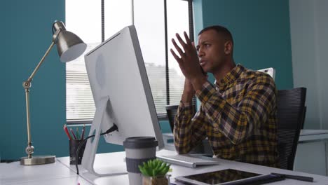 Man-speaking-on-the-phone-at-office