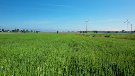 aerial drone push in towards windmills over farmlands