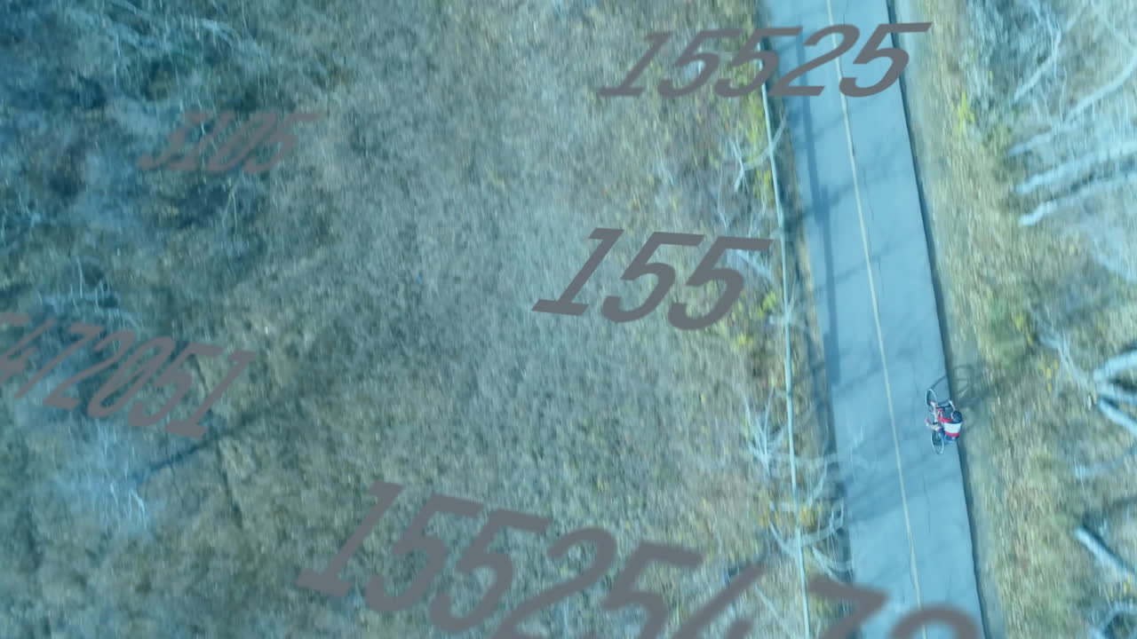 Teenage boy riding bicycle on forest trail, showing digital overlays for data mapping technology
