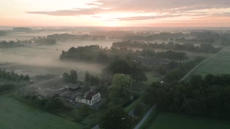 misty sunrise over dutch farmland with abandoned house