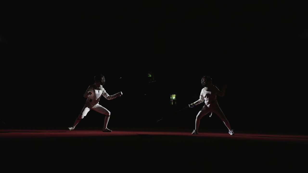 Two fencers in competition on stage