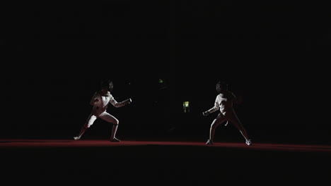 two fencers in competition on stage