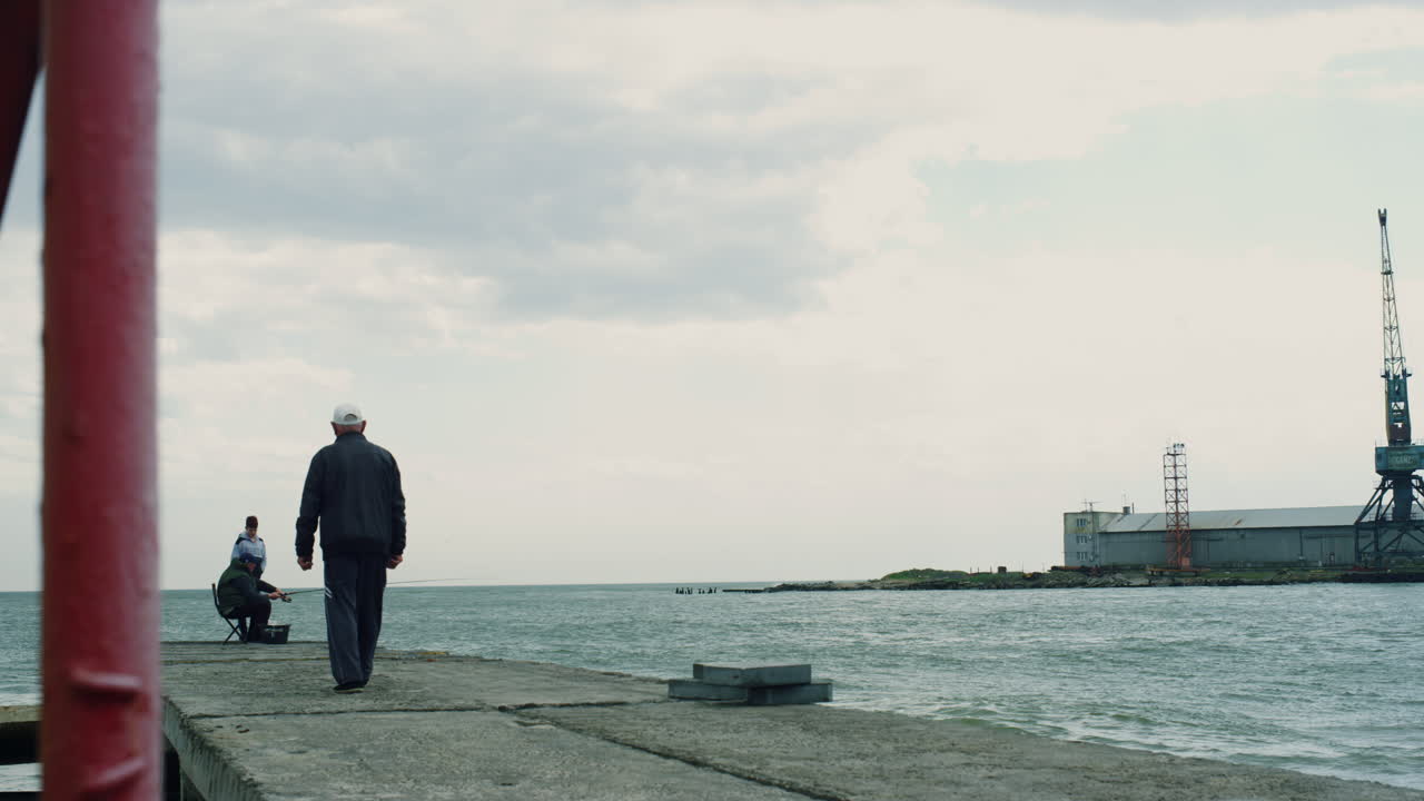 la gente de la pesca de la pesca pasa tiempo juntos al aire libre en el puente de la orilla del mar.