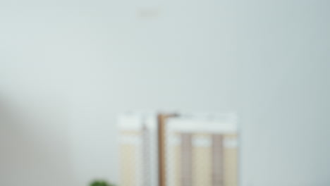 close up of two professionals sealing business agreement with handshake in office setting, symbolizing successful deal, partnership, with soft light and subtle building model in background