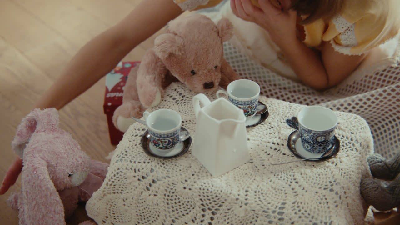 A girl playing with dolls in her room