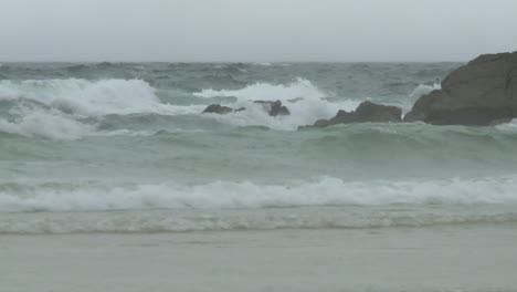 stormy ocean waves crashing on the shore
