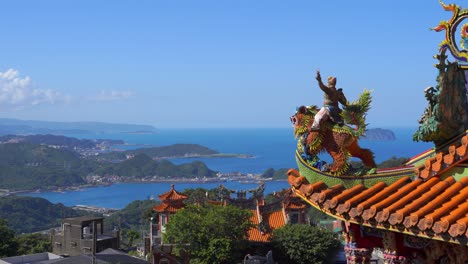 Incredible-view-out-on-blue-sea-from-high-above-with-Chinese-temple