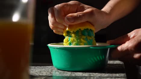 woman preparing 100% fresh orange juice using fruits squeezer - close up, selective focus