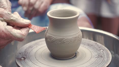 grandmother with a grandchildren make pitchers in pottery