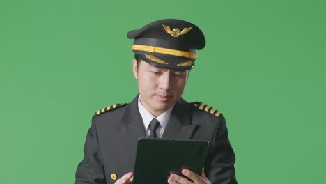 pilot using tablet on green screen