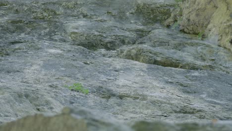 Upward-panning-shot-that-reveals-a-granite-cliff