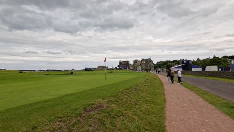 people walking near iconic golf course and clubhouse