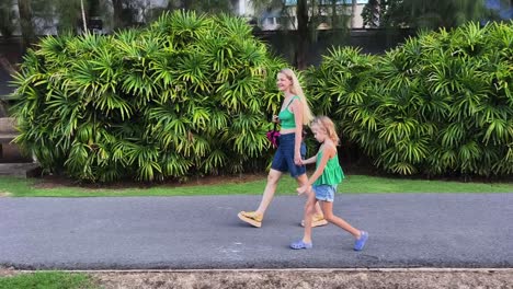 mother and daughter walking in a park