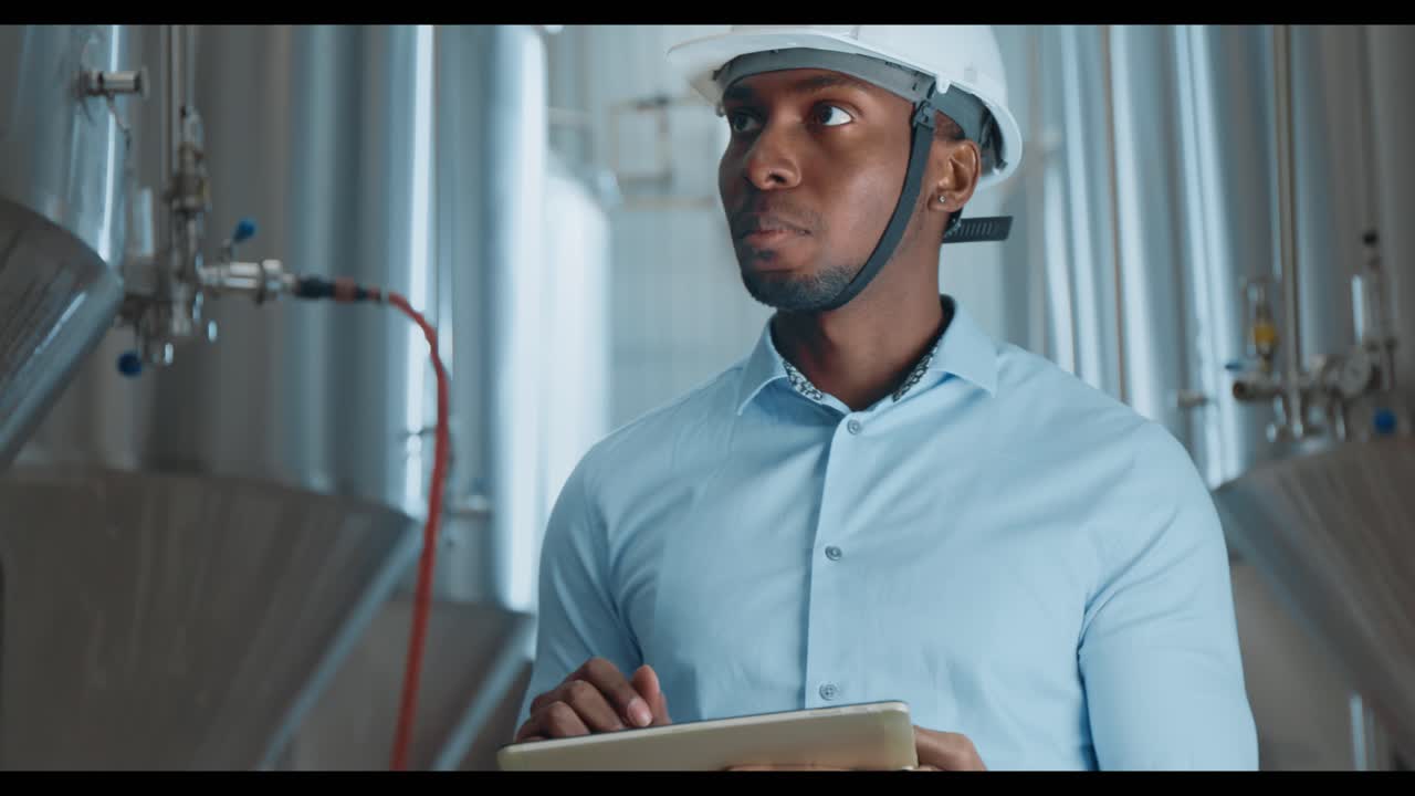 Engineer Inspecting Brewery Equipment