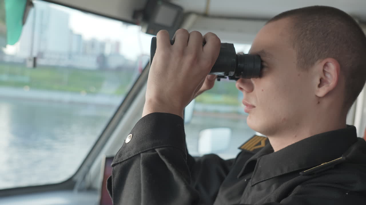 Naval Officer Using Binoculars on a Boat