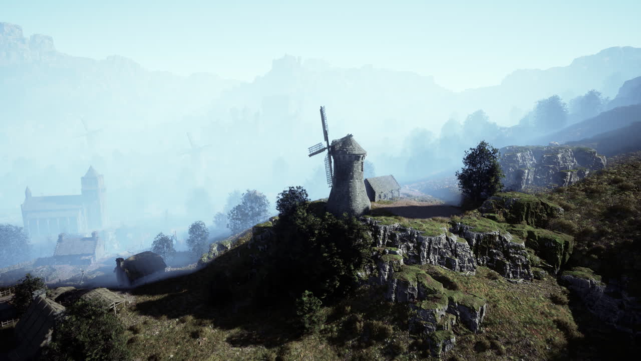 배경 에 중세 마을 이 있는 언덕 꼭대기 에 있는 풍차