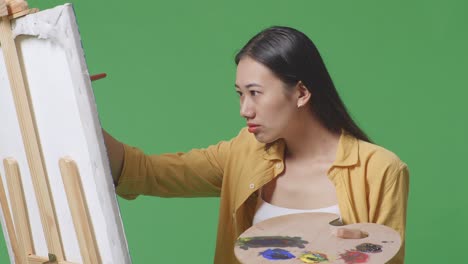 woman painting on easel