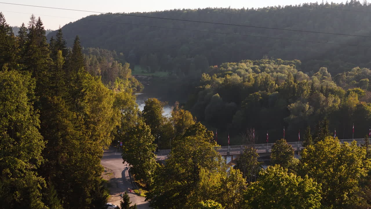 People Walking To The Landmark Bridge Over The Gauja River In Sigulda, Latvia.