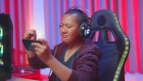 teenager playing mobile game