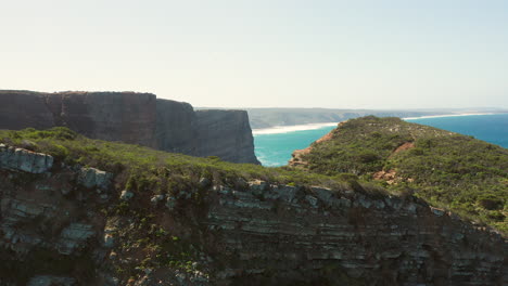 aerial: the cliffs near the town of arrifana in portugal