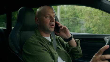 man talking on phone while driving
