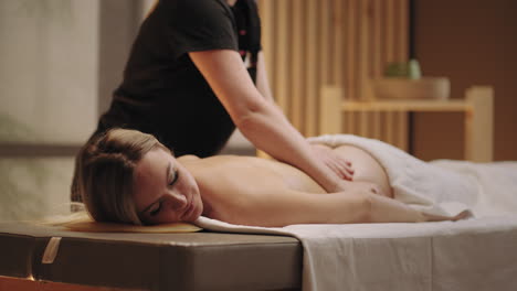 manual physician is massaging body of female patient in spa salon curing and prevention of spinal disease