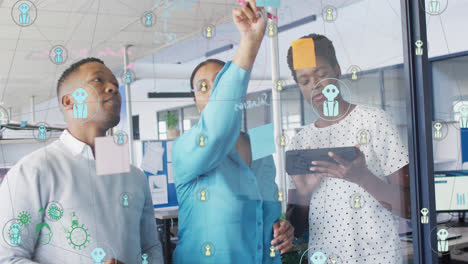 Animation-of-connected-profile-icons-over-african-american-colleagues-discussing-over-sticky-notes