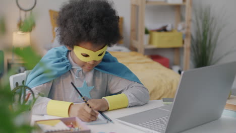 child superhero studying at home