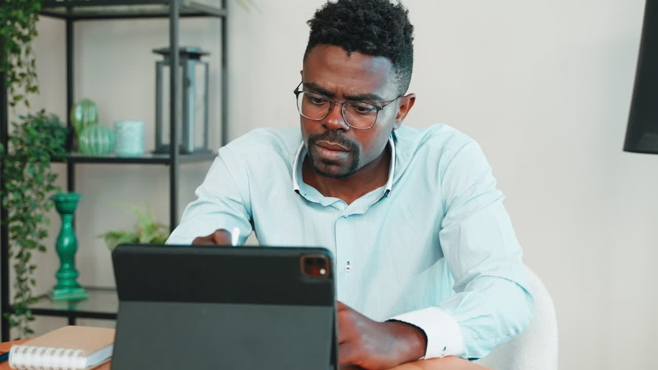 Man working on a tablet at home