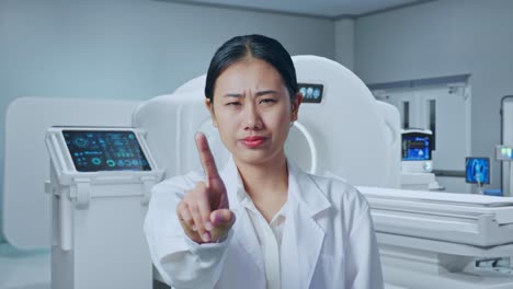 close up of asian woman doctor showing no gesture while standing with mri machine in the hospital