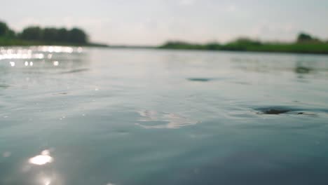 Closeup-of-freshwater-stream-creating-glints,-and-glare-on-the-water-surface