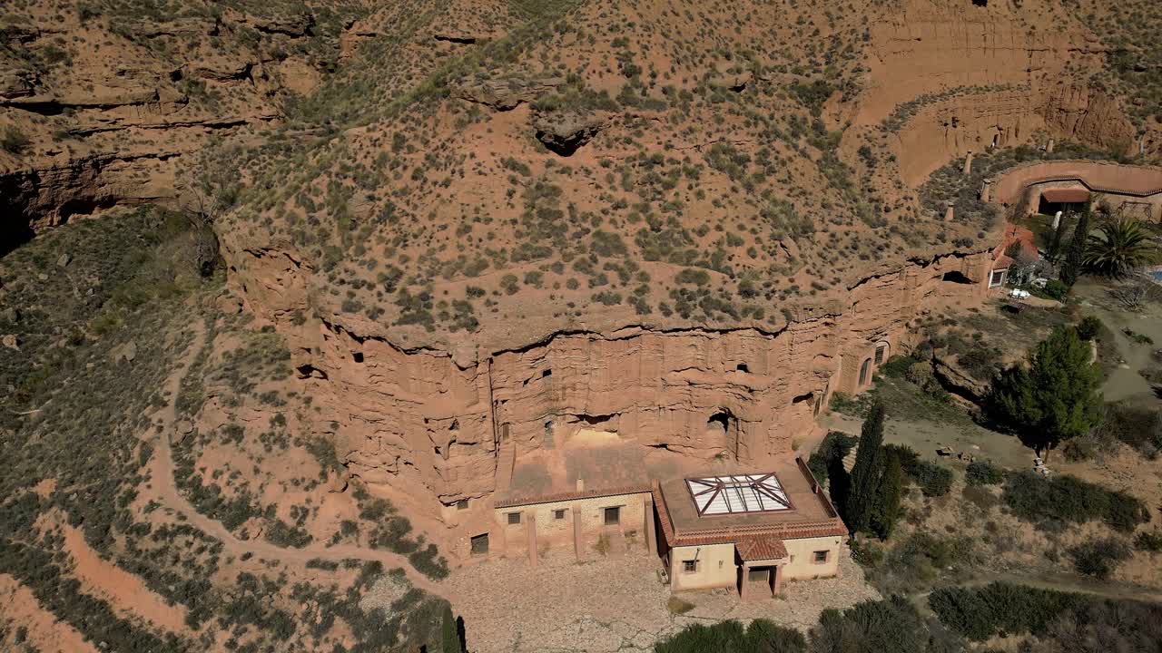 Cave houses. Facades of cave houses on a mountainside. Aerial view. Purullena. Spain.