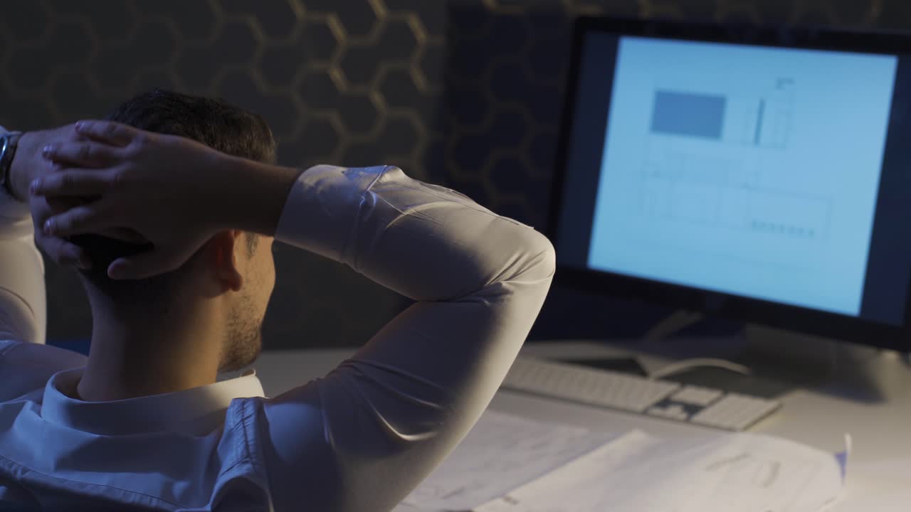 Young interior designer working in his studio. Architectural drawings.