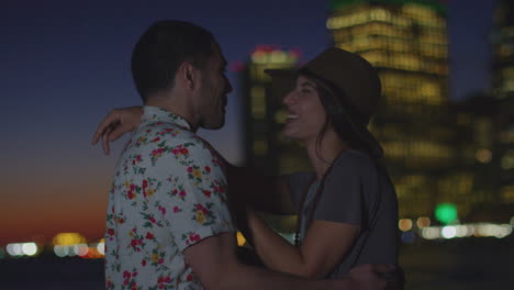 romantic couple with manhattan skyline at dusk in background