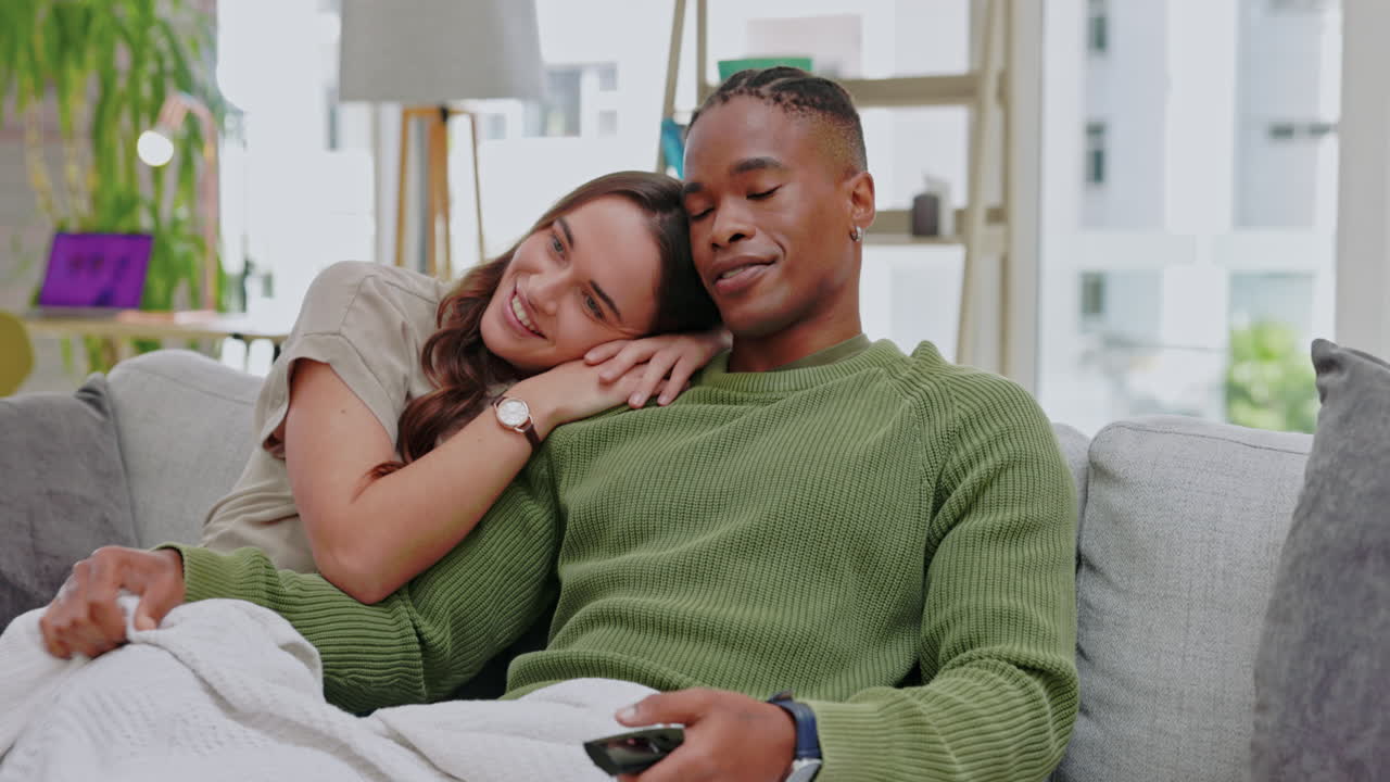 Watching tv, couple and home on a living room