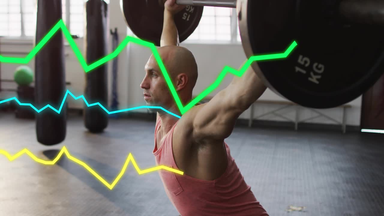 Lifter in gym dropping bar overhead, lowering into squat while graphs layering torso tracking form