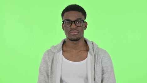 african man shaking head as yes sign on green background