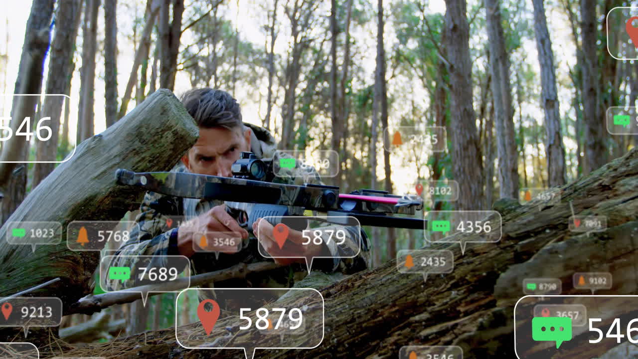 Mature man lying behind log aiming crossbow in pine forest, using AR technology icons