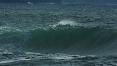 dark water swells and collapses with loud misty spray and heavy energy, slow motion compression