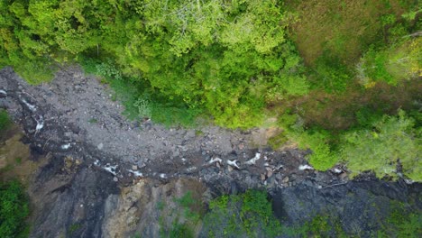 Top-down-view-of-water-streaming-in-a-small-river-in-Rio-negro-in-Colombia