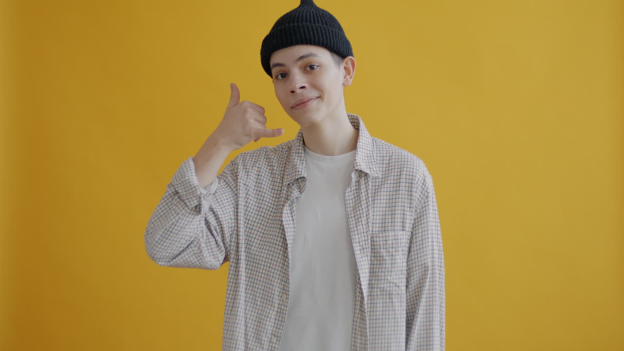 Young Man Gesturing Call