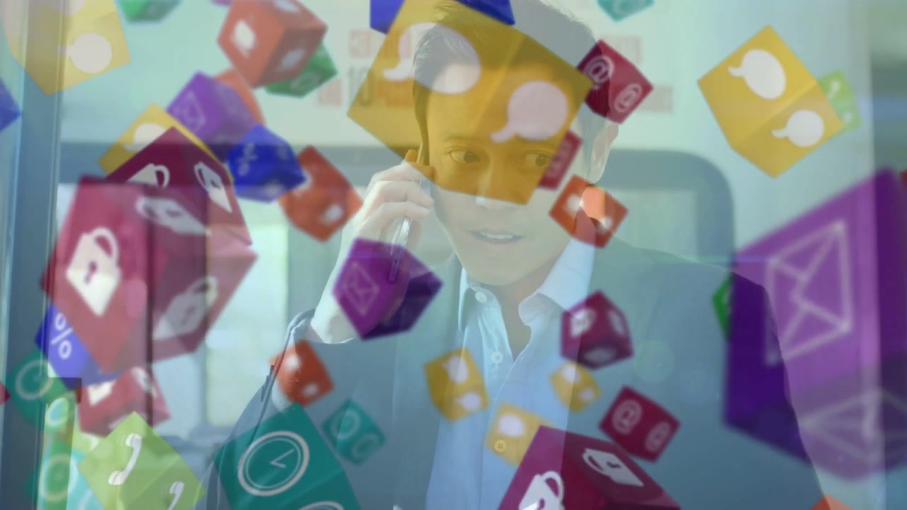 Vertical video: Asian exec in suit answering phone, responding to floating icon cubes in office