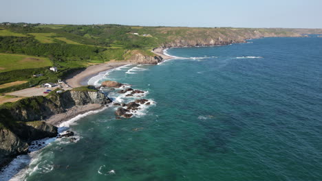a drone view of the rugged coastline on the south coast of cornwall, england near the village of kuggar and kennack sands popular with holidaymakers.