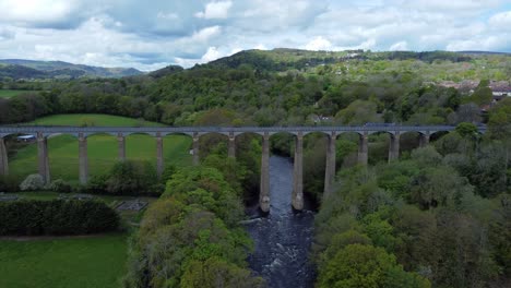 aerial view pontcysyllte aqueduct and river dee canal narrow boat bride in chirk welsh valley countryside moving forwards