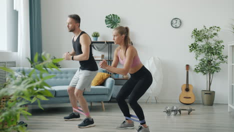 couple working out at home with resistance bands