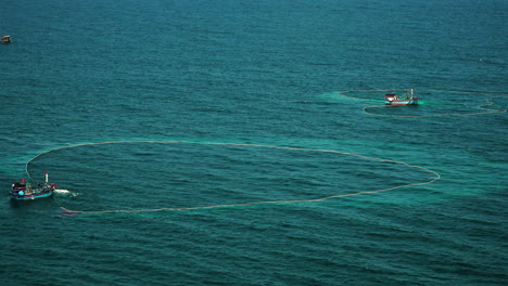 fishing vessels in the ocean catching fish with trawling nets