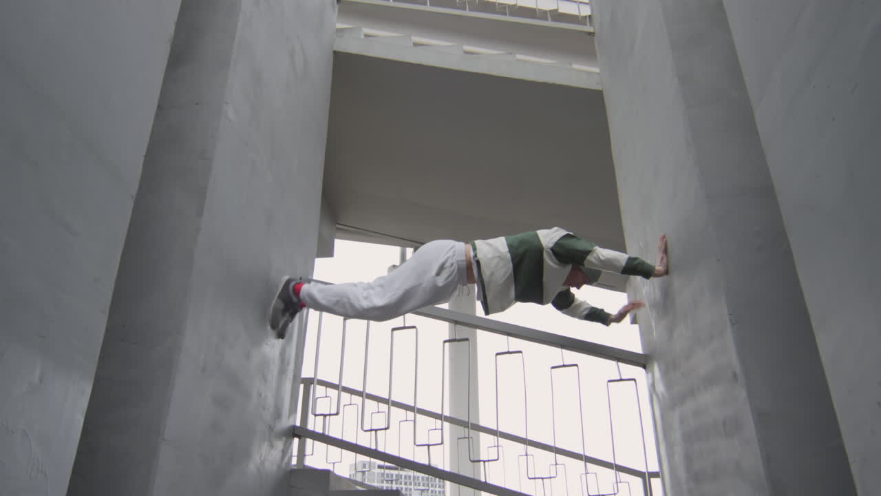 Parkour Athlete Climbing Between Two Walls