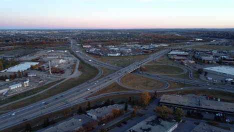 a circular drone shot of a busy highway within the city limits of calgary